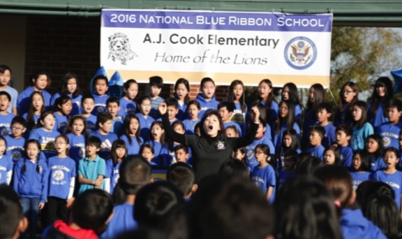 Choir students sing in honor of being awarded a National Blue Ribbon school.