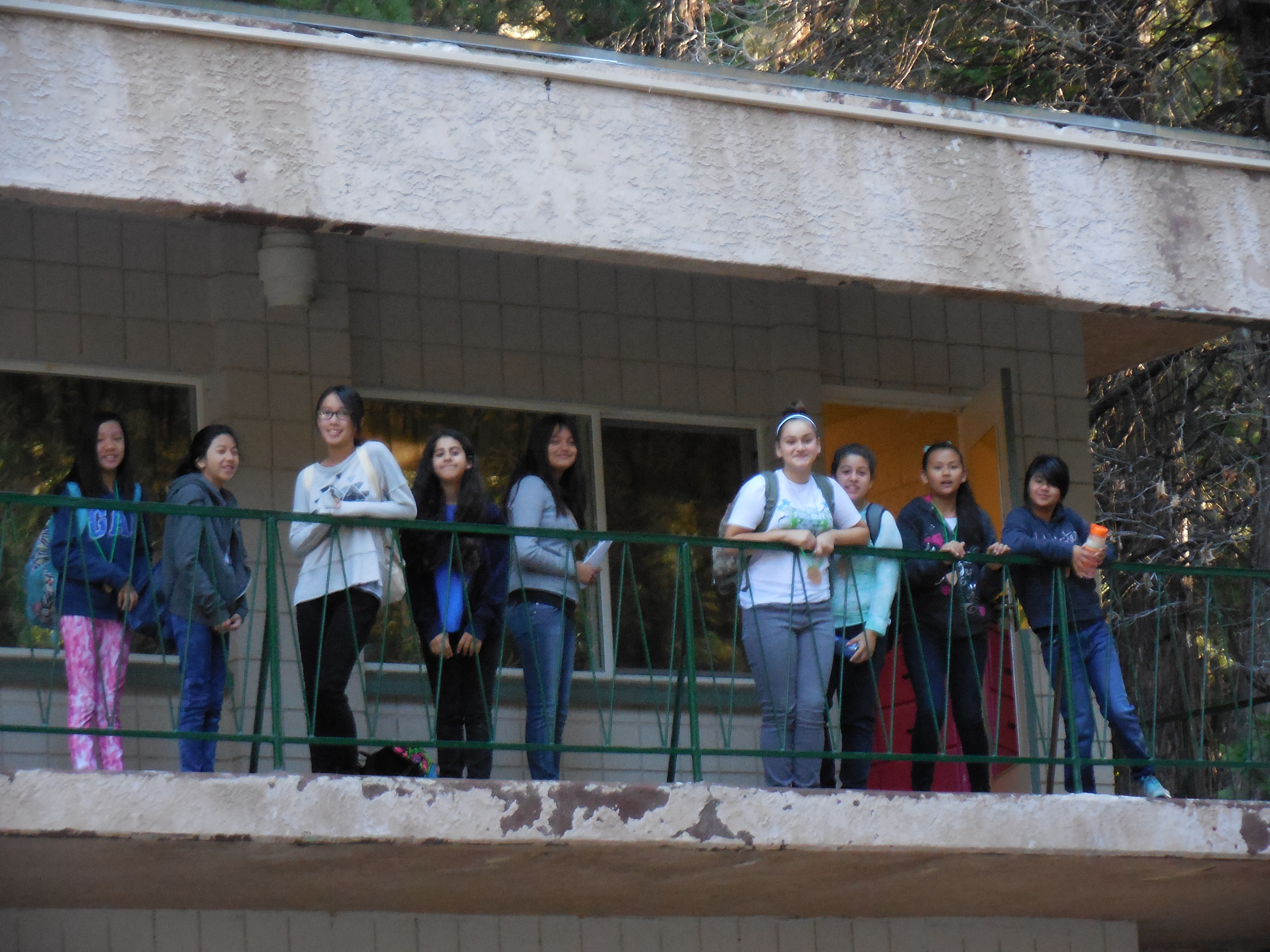 Students stand outside their rooms early in the morning, ready to explore the vast outdoors.