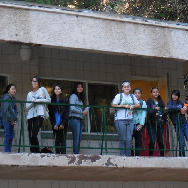 Students stand outside their rooms early in the morning, ready to explore the vast outdoors.