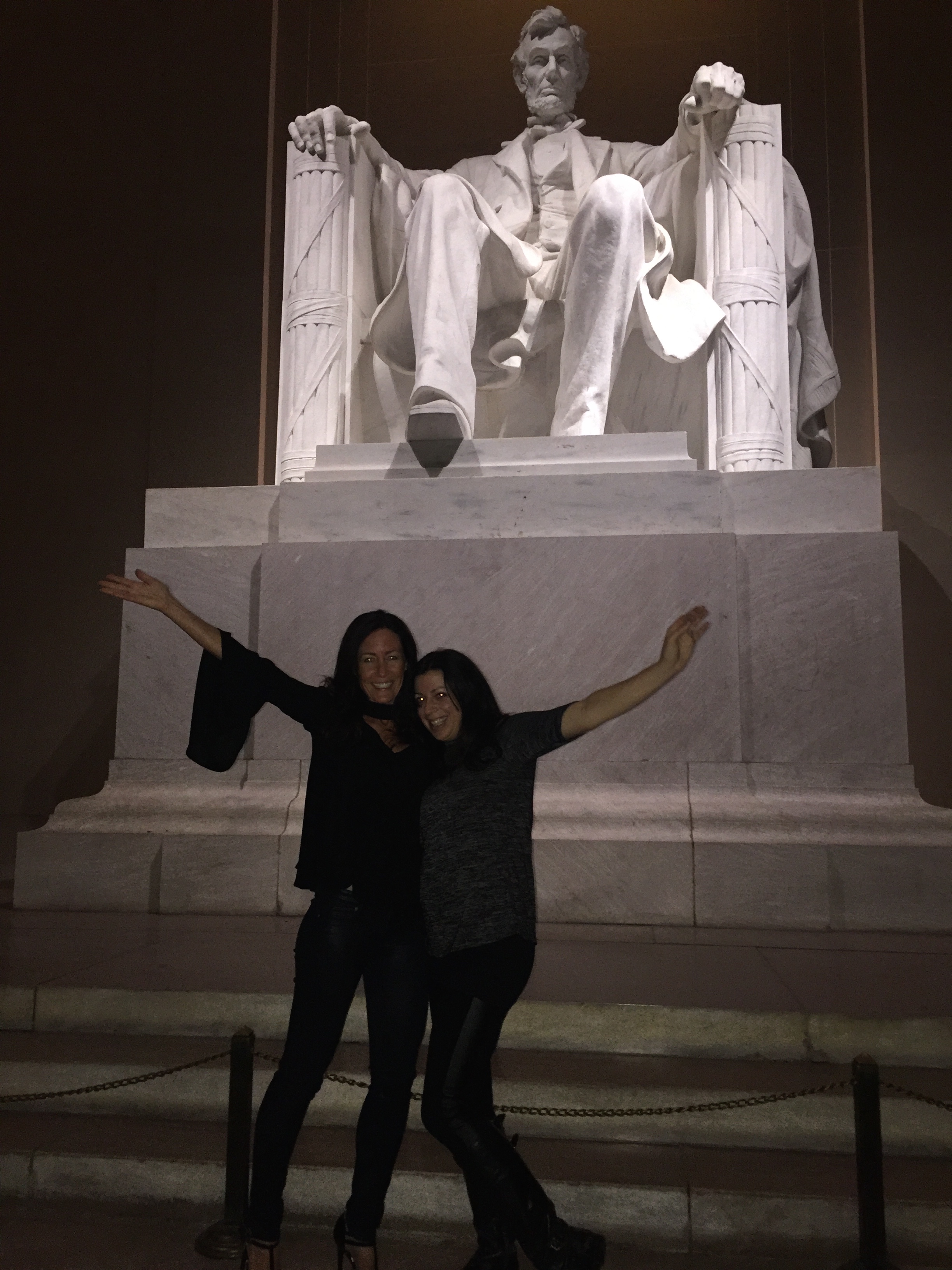 These two friends pose for a photo in front of Abraham Lincoln's statue.