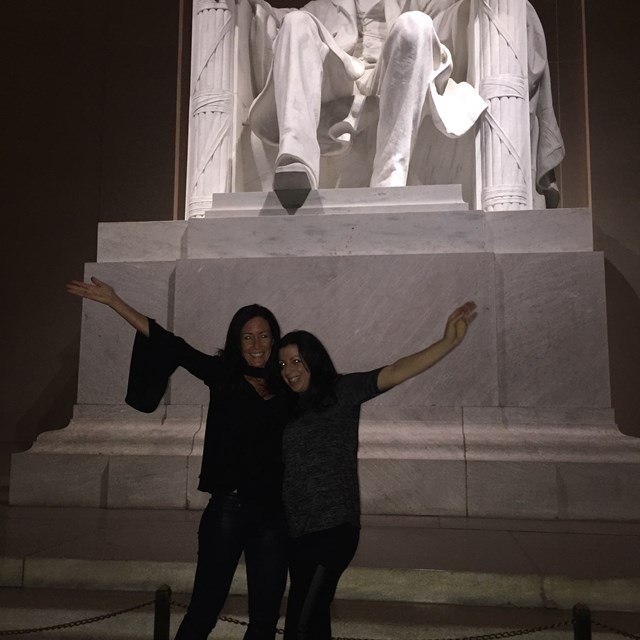 These two friends pose for a photo in front of Abraham Lincoln's statue.