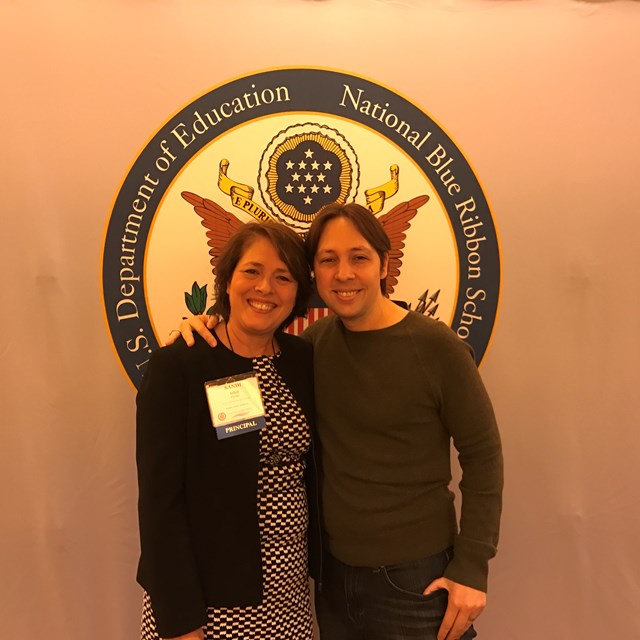 Teachers are proud to accept the National Blue Ribbon award.